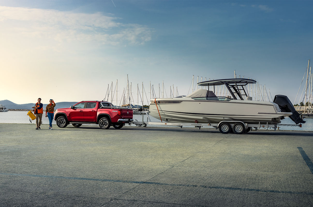 red amarok towing boat at dock
