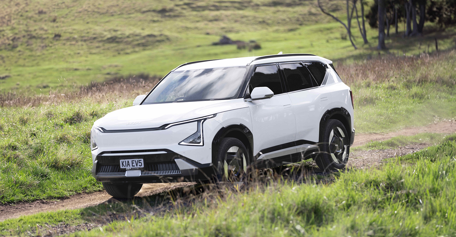 White Kia EV5 driving in New Zealand